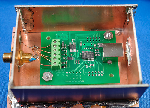 Image of shield (with cover removed) around a small pc board