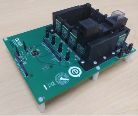 Image of fully assembled Analog Device EVAL-CN503-ARDZ on top of the EVAL-AIDCUP3029