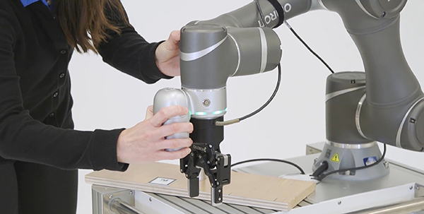 Image of cobot can be trained by moving its arm from position to position