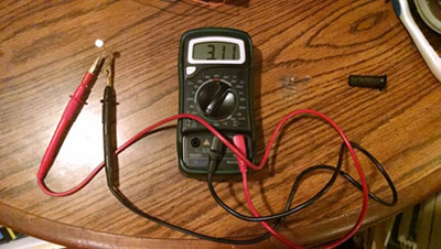 ohmmeter reads a value of 3.11Kilo-ohms