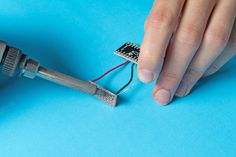 Solder a + and - lead to VCC and GND of your Qduino