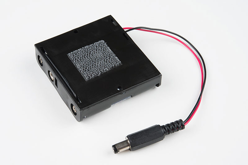attach one piece to the back of the battery holder
